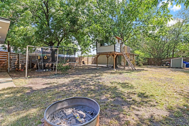 view of yard featuring a fenced backyard and a trampoline