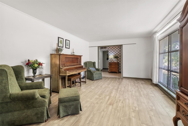 sitting room featuring light wood-style flooring and baseboards