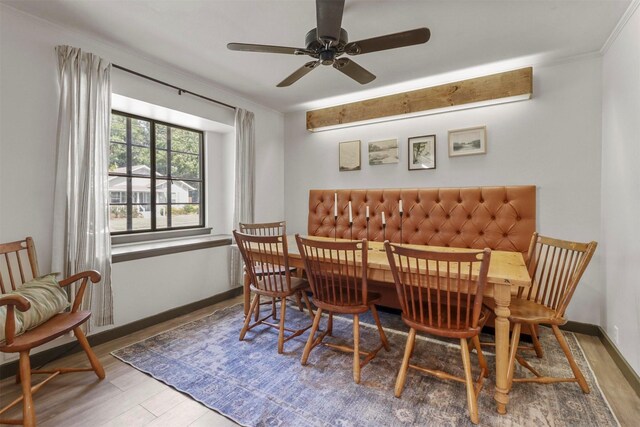 dining space featuring ceiling fan, baseboards, and wood finished floors