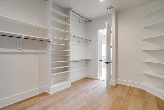 spacious closet featuring visible vents and light wood-style flooring