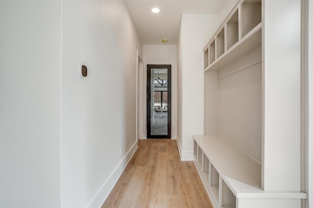 mudroom with recessed lighting, light wood-type flooring, and baseboards