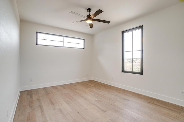 empty room with light wood-style flooring, baseboards, and ceiling fan