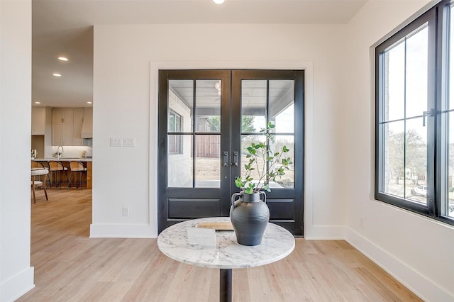 foyer entrance featuring recessed lighting, french doors, baseboards, and light wood-style floors