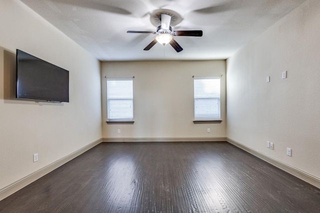 empty room with a ceiling fan, dark wood-style floors, and baseboards