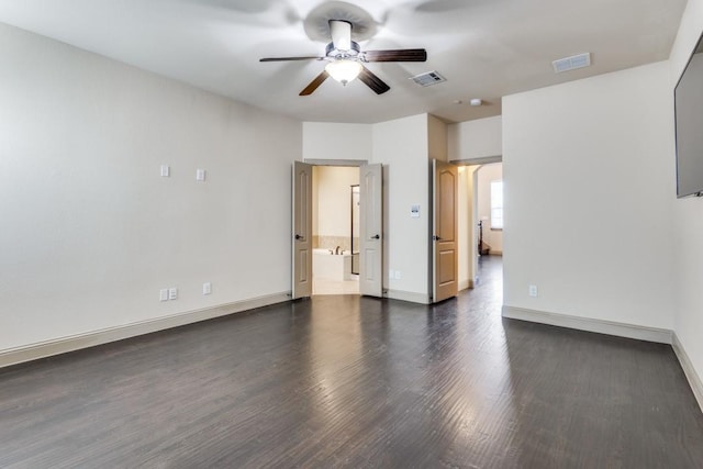 unfurnished room with dark wood finished floors, a ceiling fan, visible vents, and baseboards