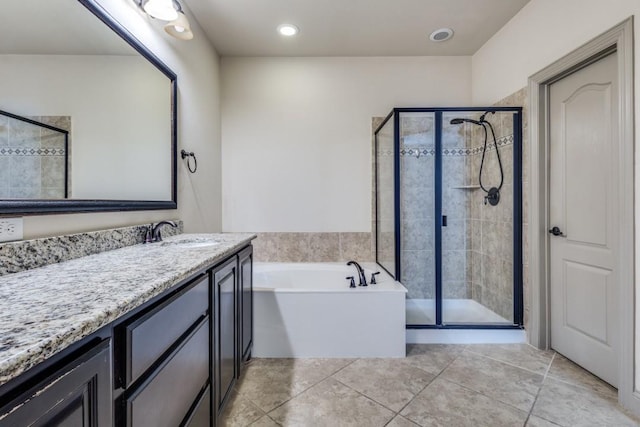 full bath featuring a bath, tile patterned flooring, a stall shower, and vanity