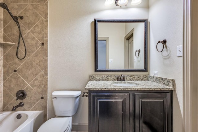 bathroom featuring shower / washtub combination, toilet, and vanity