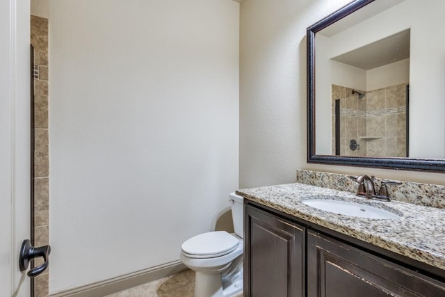 full bath with vanity, toilet, and a tile shower