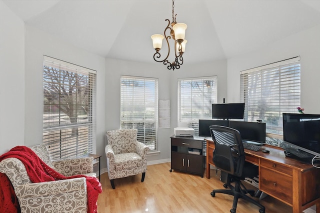 home office featuring light wood-type flooring, baseboards, a chandelier, and vaulted ceiling