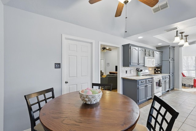 dining room with light tile patterned floors, visible vents, ceiling fan, and recessed lighting