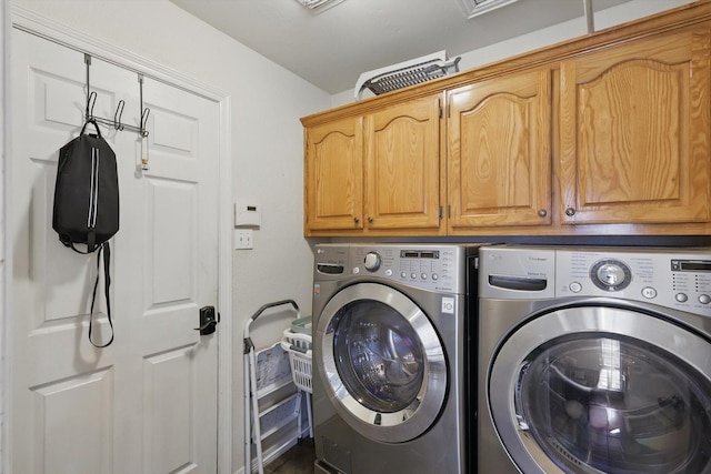 laundry room featuring cabinet space and separate washer and dryer