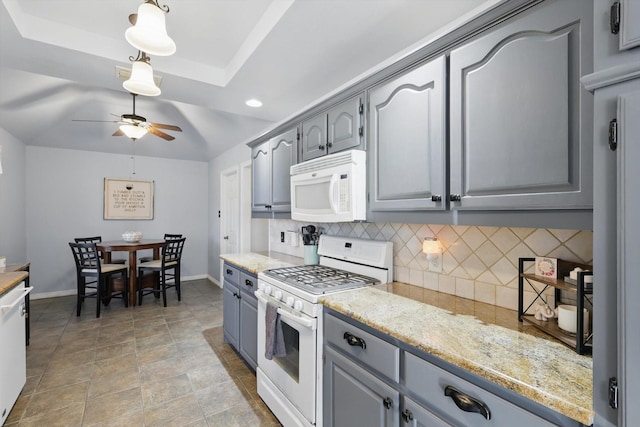 kitchen with white appliances, baseboards, gray cabinets, ceiling fan, and backsplash