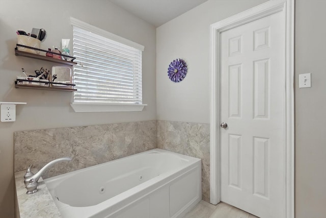 bathroom with tile patterned floors and a jetted tub