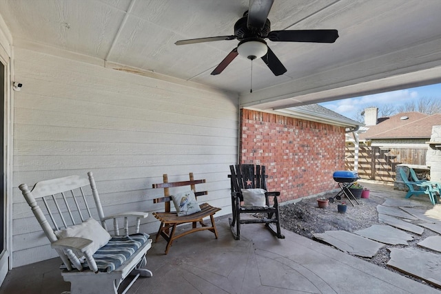 view of patio featuring a ceiling fan and fence