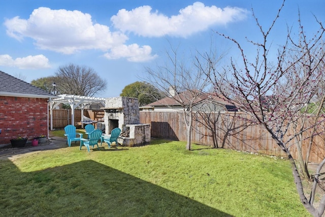 view of yard featuring a patio, a fenced backyard, a pergola, and an outdoor stone fireplace