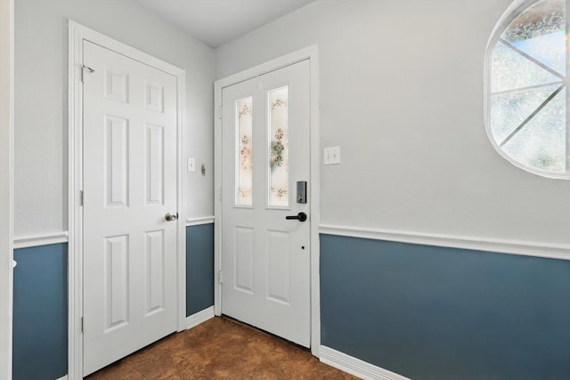 foyer entrance featuring baseboards