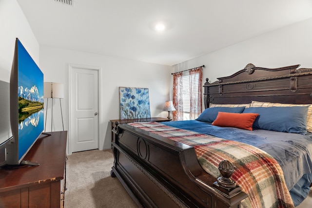 carpeted bedroom featuring visible vents