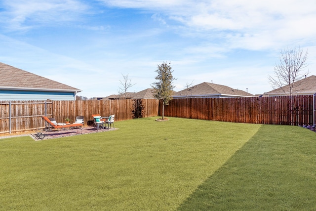 view of yard with a fenced backyard and a patio area