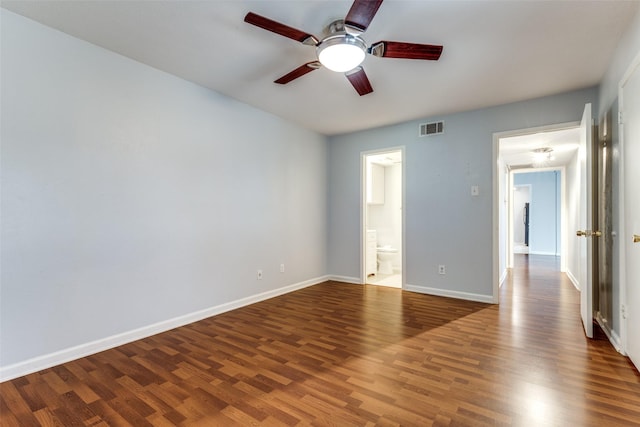 unfurnished room with ceiling fan, wood finished floors, visible vents, and baseboards