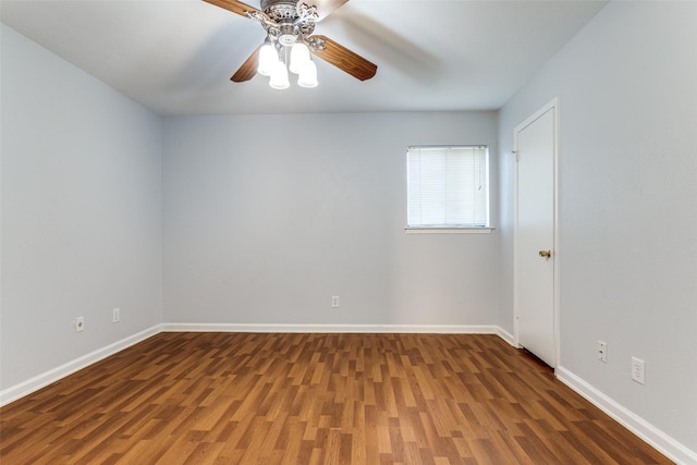 empty room with a ceiling fan, wood finished floors, and baseboards