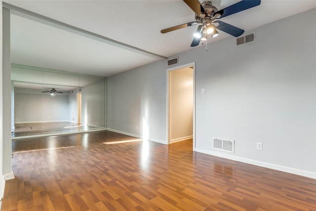 spare room with visible vents, ceiling fan, and wood finished floors