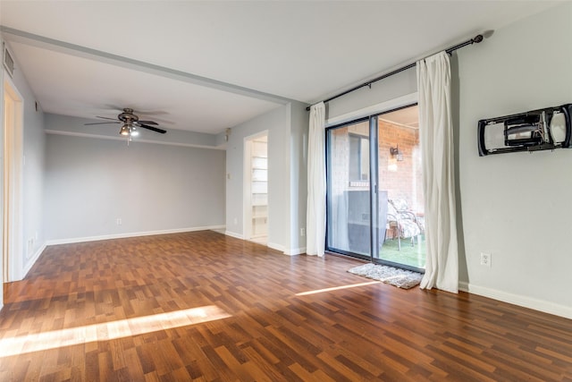 unfurnished room featuring ceiling fan, baseboards, and wood finished floors