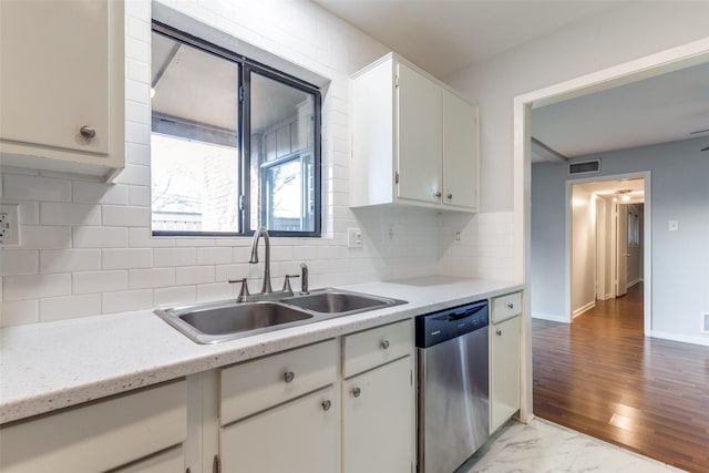 kitchen featuring visible vents, a sink, light countertops, stainless steel dishwasher, and marble finish floor