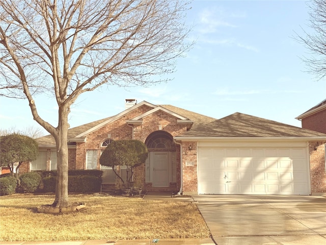 view of front of house with brick siding, concrete driveway, a front yard, and a shingled roof