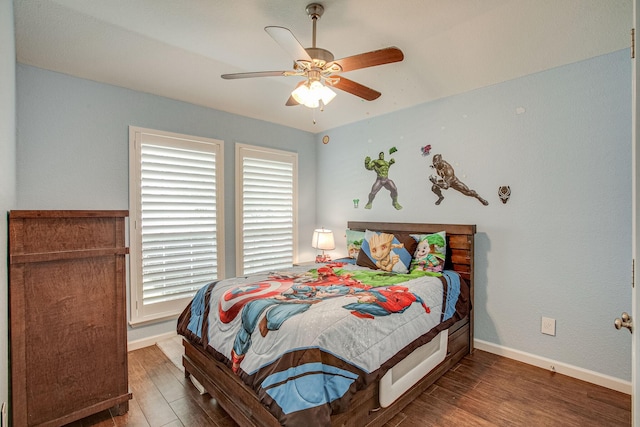 bedroom with baseboards, wood finished floors, and a ceiling fan