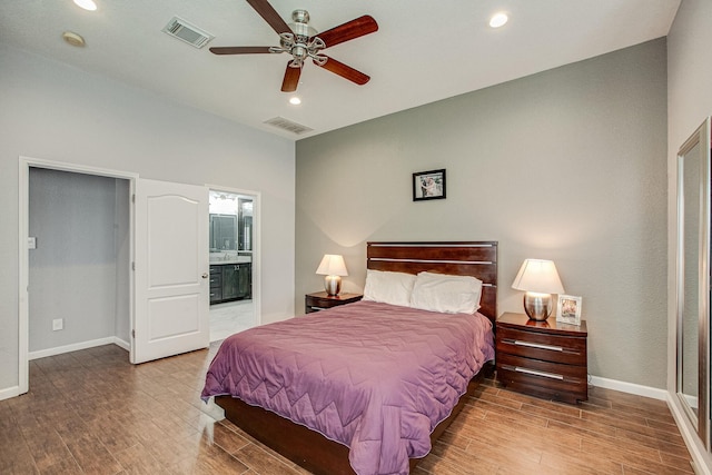 bedroom with visible vents, baseboards, and wood finished floors