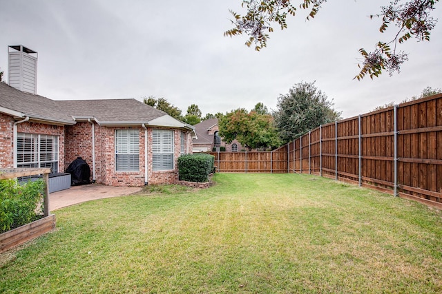 view of yard featuring a patio and a fenced backyard