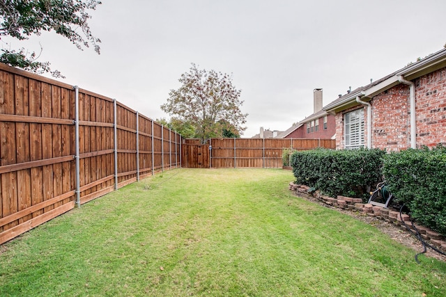 view of yard with a fenced backyard