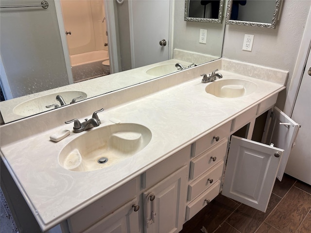 full bath with a sink and double vanity