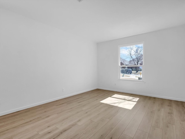 unfurnished room featuring wood finished floors and baseboards