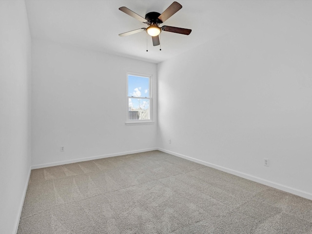 spare room with baseboards, carpet floors, and ceiling fan