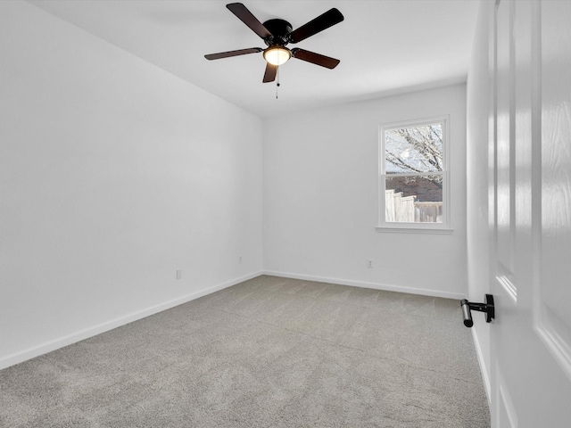 unfurnished room with baseboards, ceiling fan, and carpet flooring