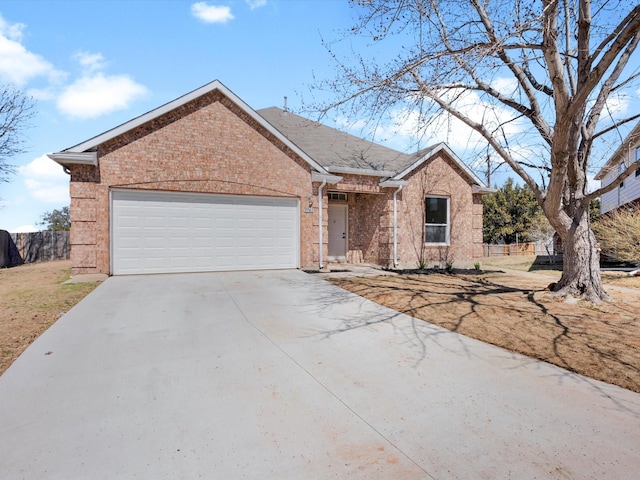 single story home featuring brick siding, concrete driveway, an attached garage, and fence