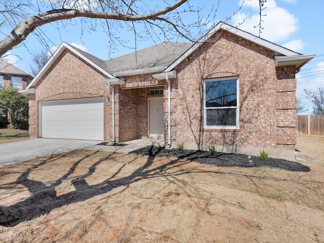 ranch-style home featuring a garage, brick siding, driveway, and fence