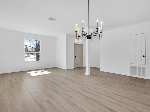 unfurnished dining area with visible vents, baseboards, and light wood-style flooring