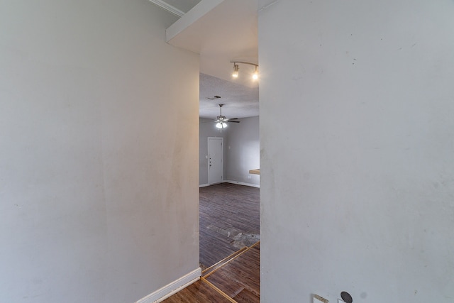 hallway with wood finished floors and baseboards