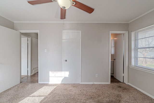 unfurnished bedroom with a closet, carpet flooring, and crown molding