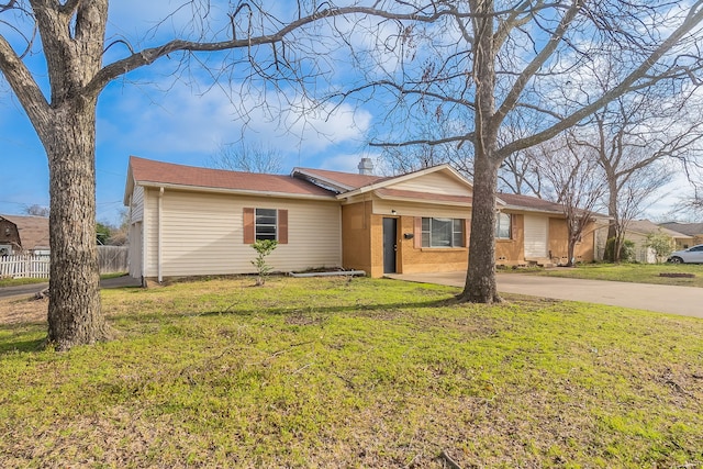 single story home with brick siding, a front lawn, fence, concrete driveway, and a chimney