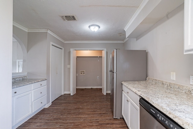 kitchen with visible vents, dark wood-style flooring, ornamental molding, appliances with stainless steel finishes, and white cabinetry