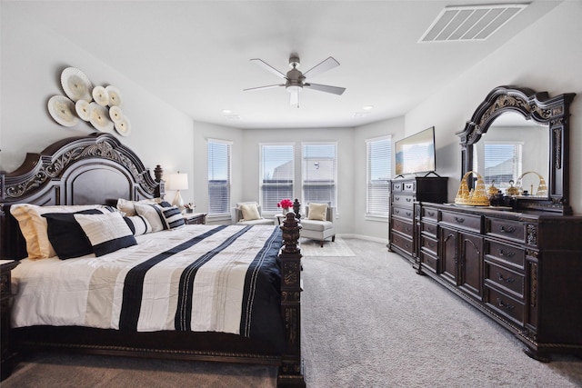 bedroom with visible vents, baseboards, light colored carpet, and a ceiling fan