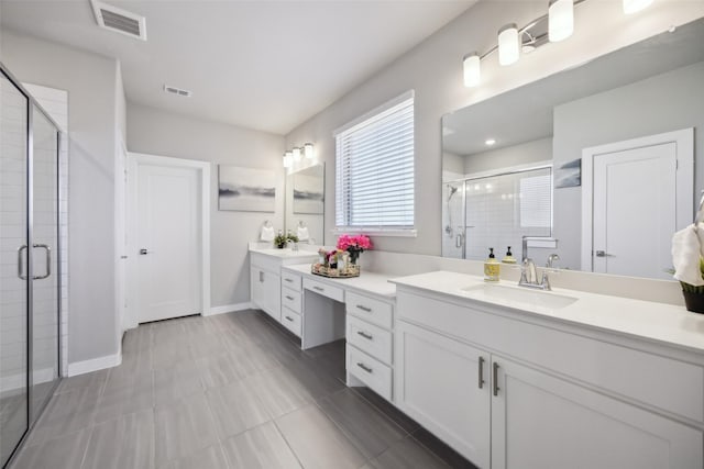 bathroom featuring visible vents, a shower stall, vanity, and baseboards