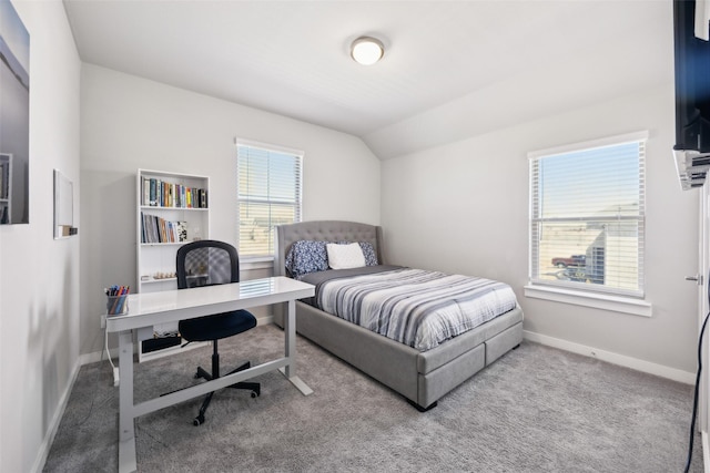 bedroom with carpet flooring, lofted ceiling, multiple windows, and baseboards