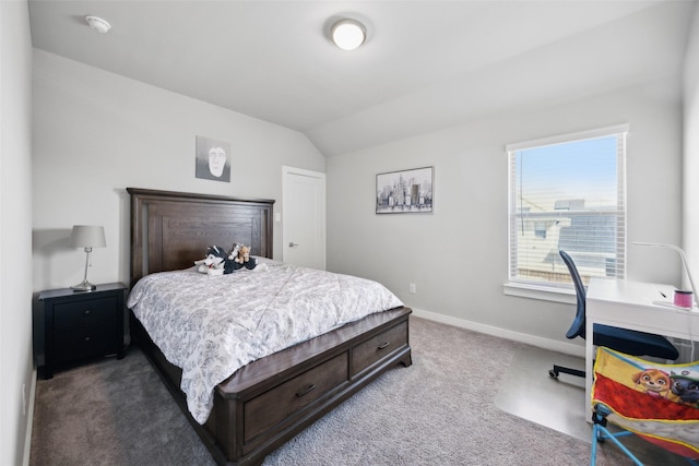 bedroom featuring dark carpet, baseboards, and lofted ceiling