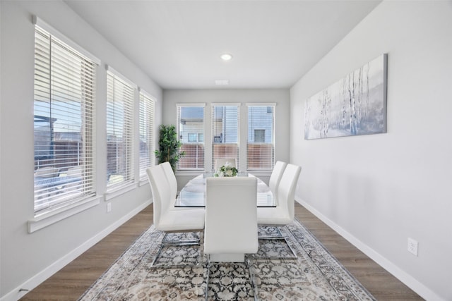 dining room featuring baseboards and dark wood-style floors