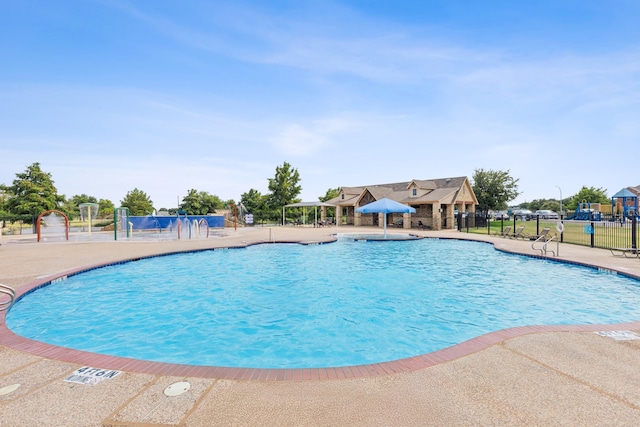 pool featuring a patio area and fence