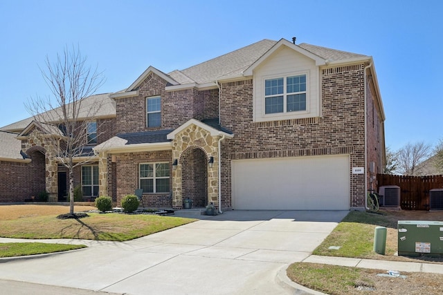 view of front of property with driveway, fence, cooling unit, a garage, and brick siding